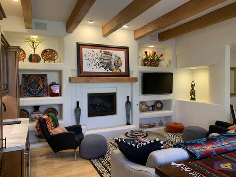 Native American wall art in frame above a fireplace. Headdress of feathers with flock of birds. Art by Dolan Geiman.