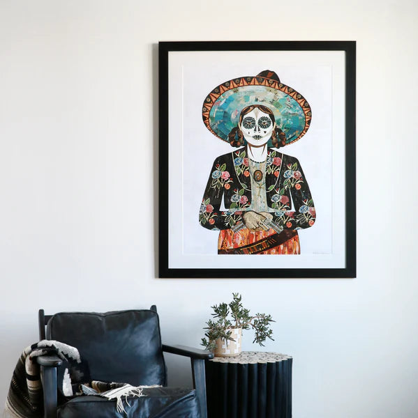 The striking silhouette of this Mexican woman hangs above a modern black lounge chair | Senorita Flores 32 x 40 print framed in black by Dolan Geiman