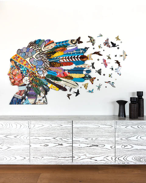 Metal wall sculpture of Native American woman with feathered headdress and flock of birds and insects