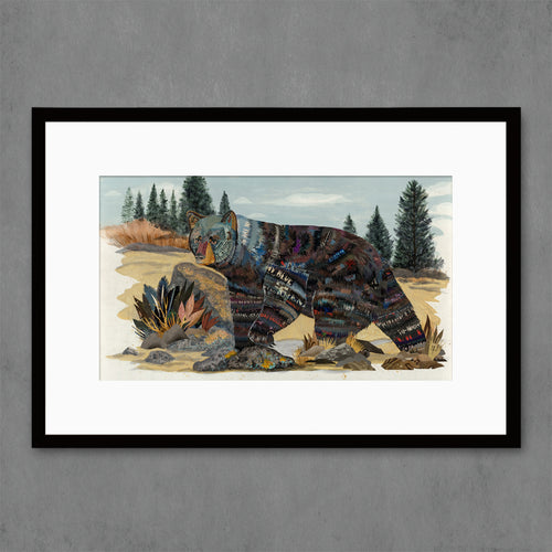 black bear wall art print shown in mountain landscape with pine trees